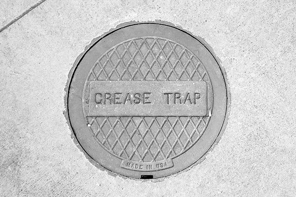 grease trap pumping involves removing the accumulated grease and solid waste from the trap using specialized equipment